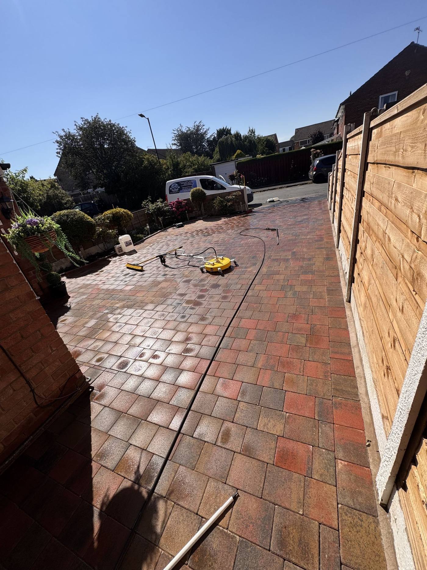 Finished block paving driveway after pressure washing in Prestwich, Greater Manchester, with C&C Precision van on the street